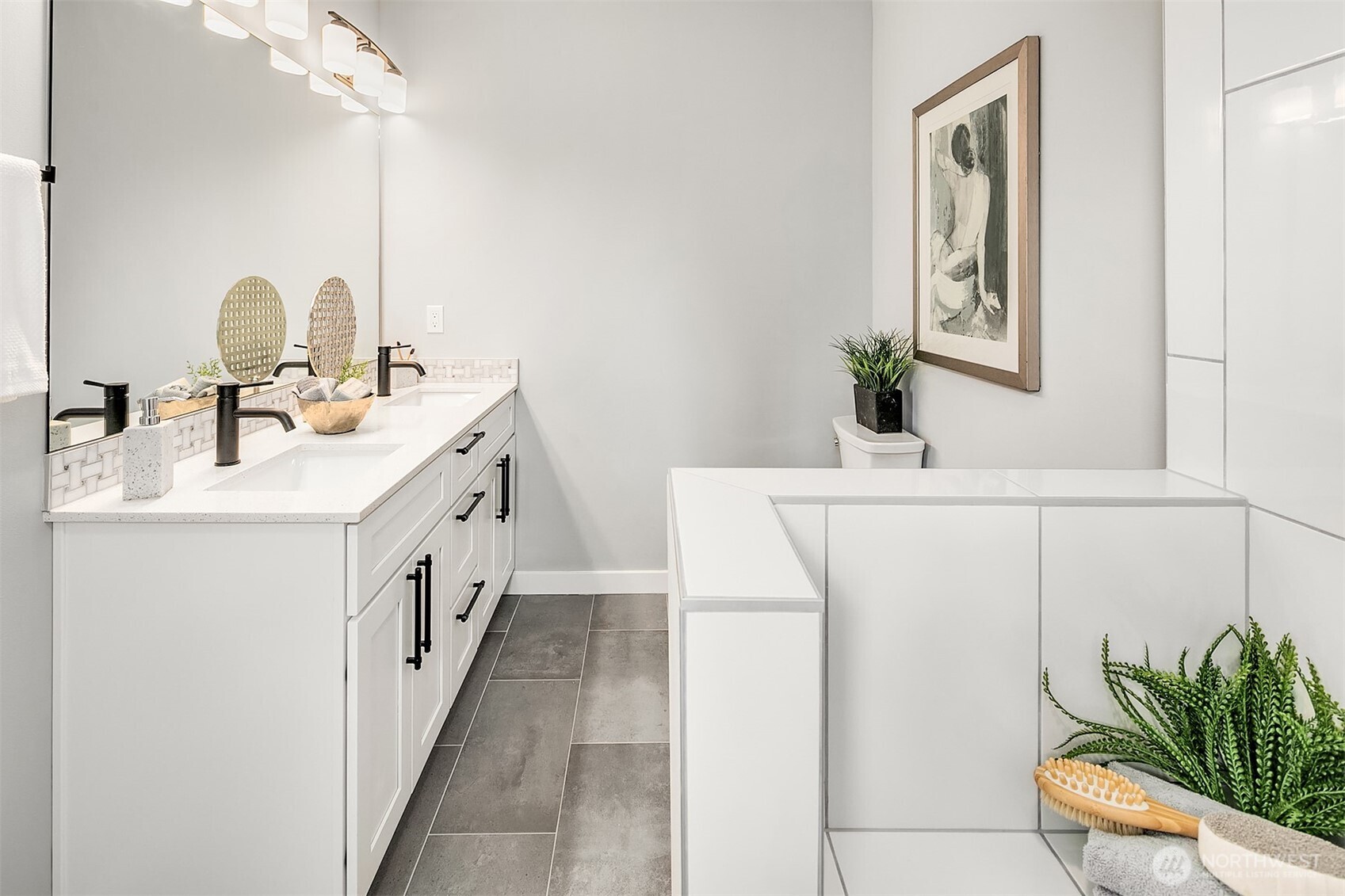 7528 215th Street Southwest, Unit 101 Edmonds, WA 98026 - Photo 19 of 29 a bathroom with a sink a mirror and a potted plant