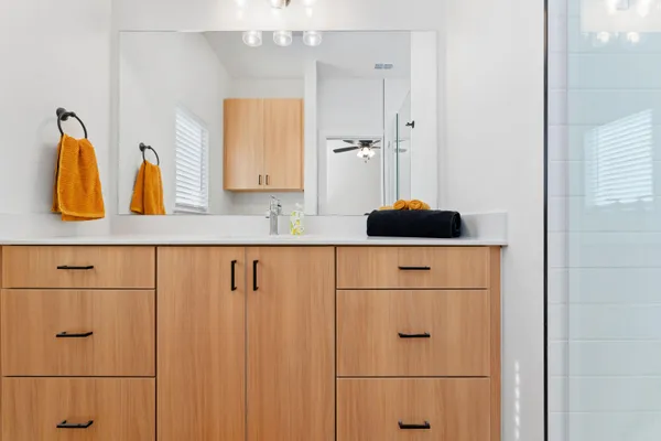 a kitchen with stainless steel appliances granite countertop a sink a stove a refrigerator and island with wooden floor
