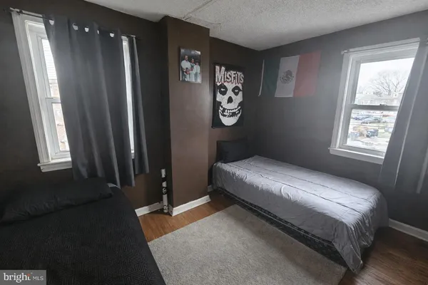 a bedroom with a bed lamp and window