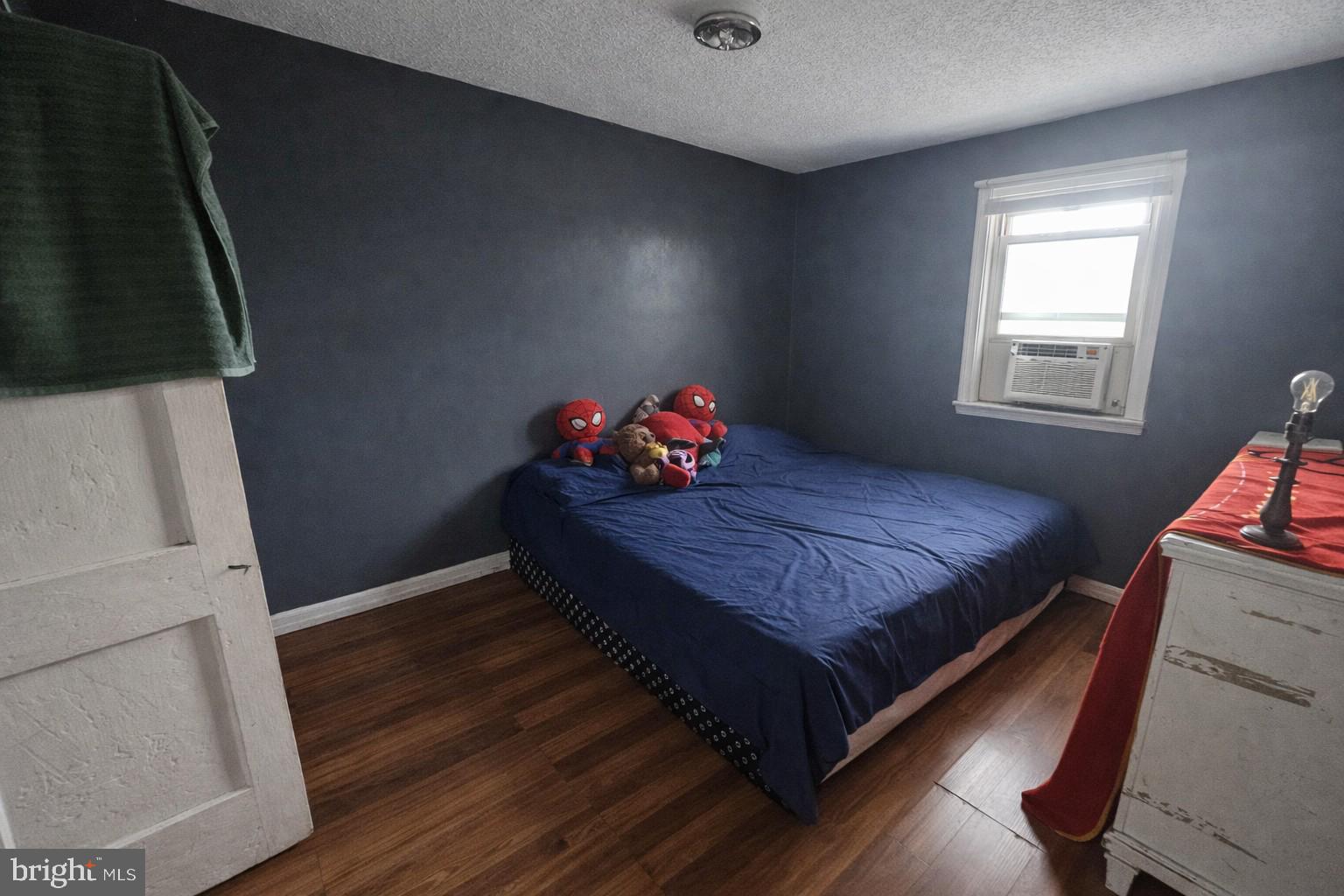 1438 Perkins Street Chester, PA 19013 - Photo 7 of 10 a bedroom with a bed and wooden floor