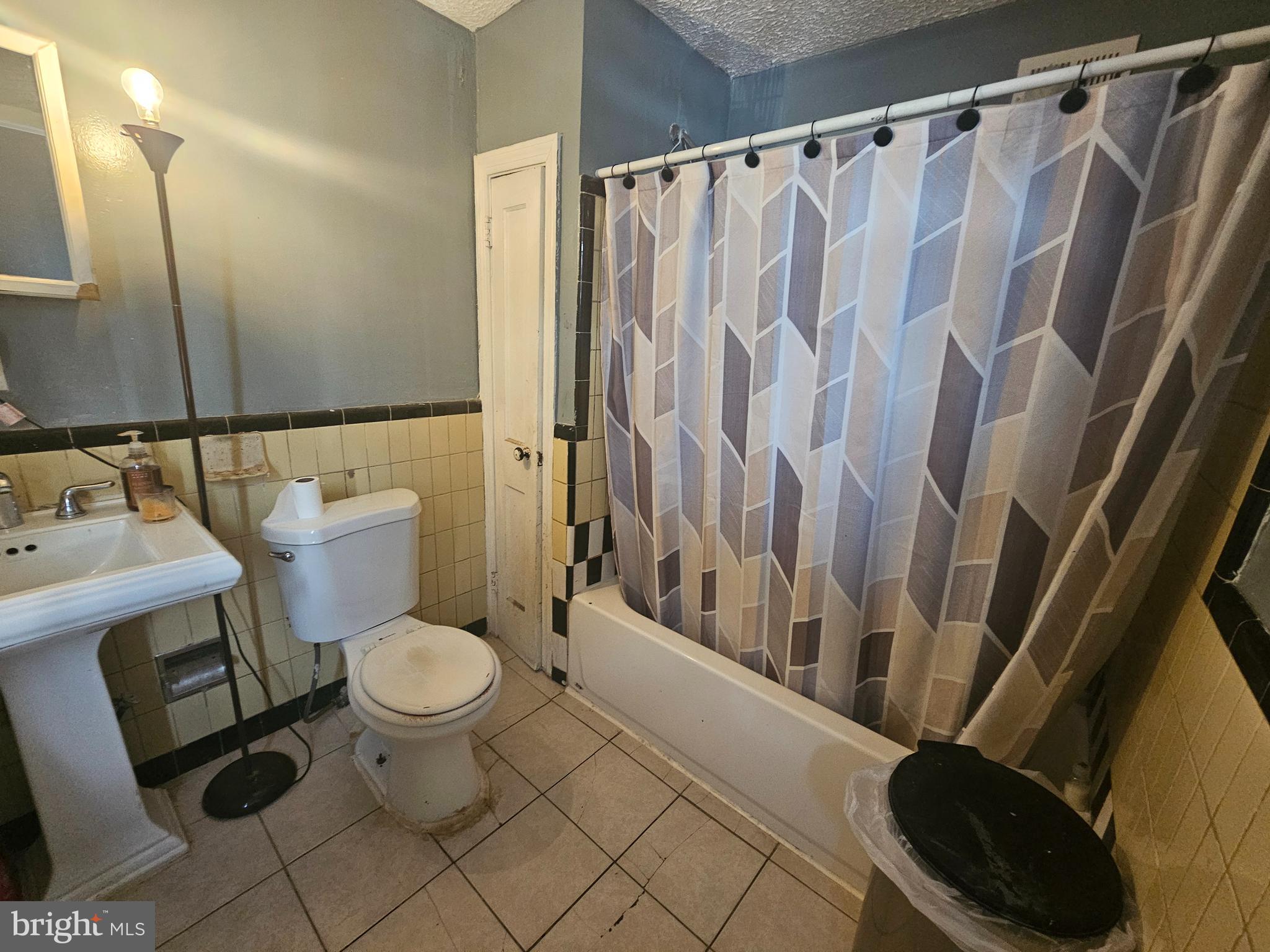 1438 Perkins Street Chester, PA 19013 - Photo 8 of 10 a bathroom with a sink toilet and shower