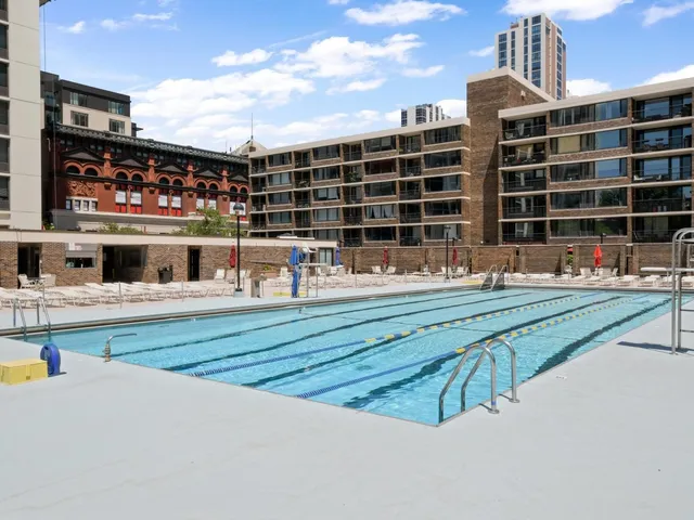 a swimming pool with outdoor seating and yard view
