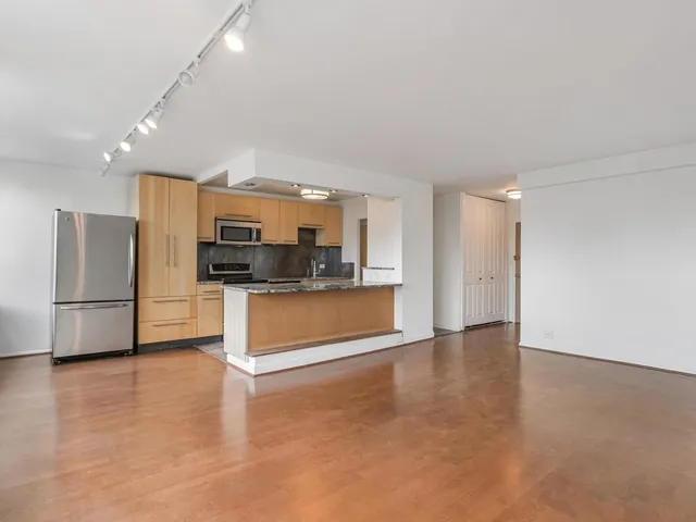 a kitchen with stainless steel appliances a refrigerator and a stove top oven
