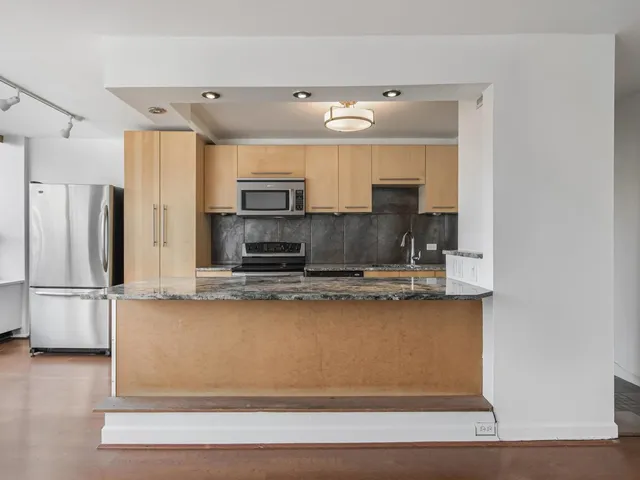 a kitchen with stainless steel appliances a sink and a refrigerator