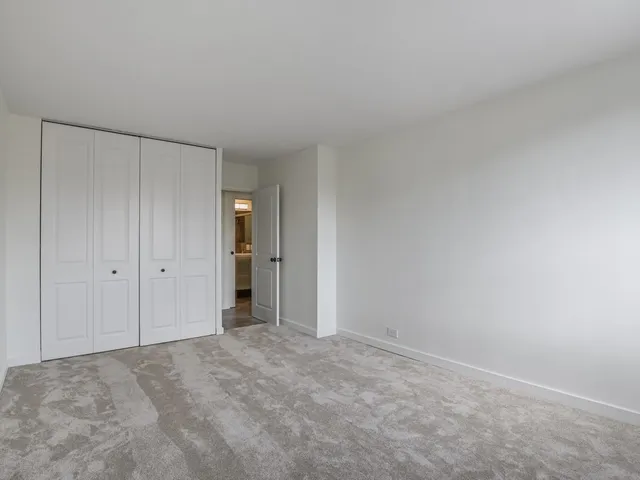 a view of an empty room and closet area