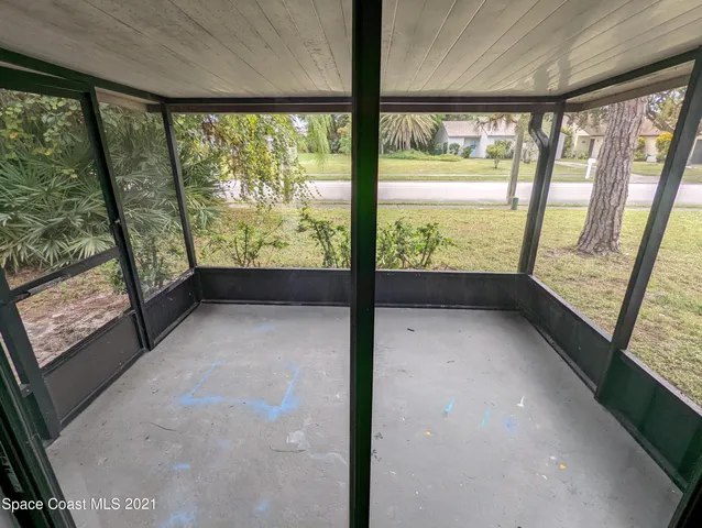 a view of an empty room and a window