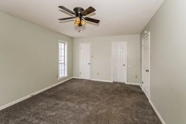 a view of room with a ceiling fan