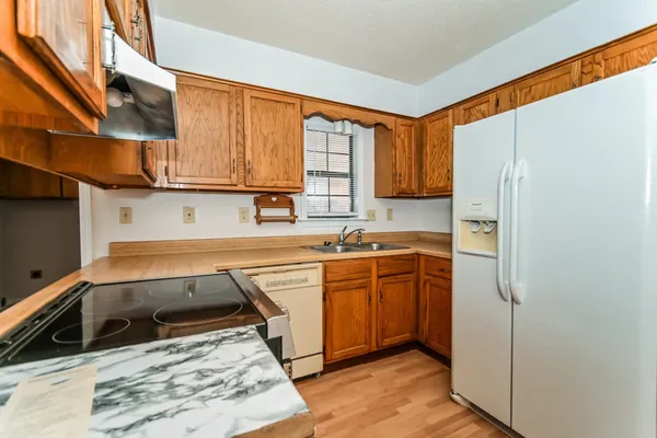 a kitchen with stainless steel appliances granite countertop a refrigerator sink and cabinets