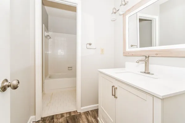 a bathroom with a sink and mirror