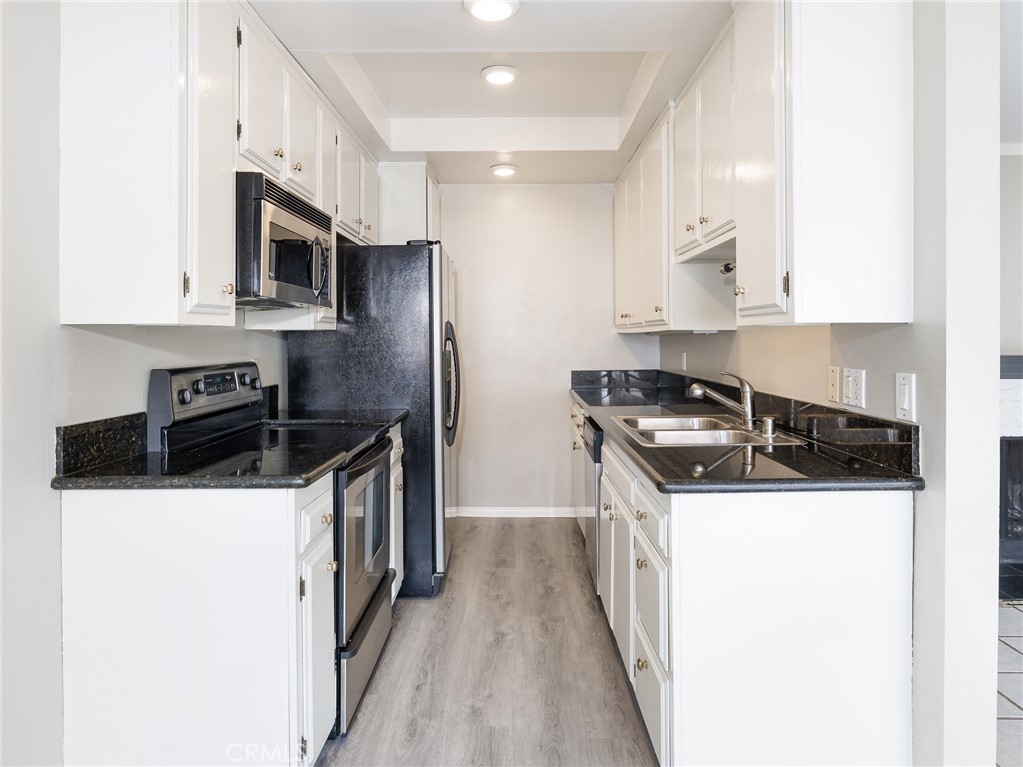 2015 Bataan Road, Unit 105 Redondo Beach, CA 90278 - Photo 10 of 29 a kitchen with stainless steel appliances a sink a stove and a refrigerator