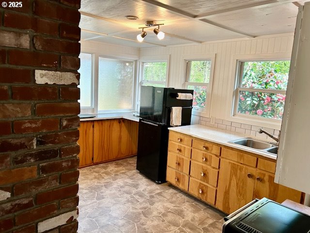 766 Foothill Drive Eugene, OR 97405 - Photo 11 of 12 a kitchen with granite countertop a refrigerator and a stove