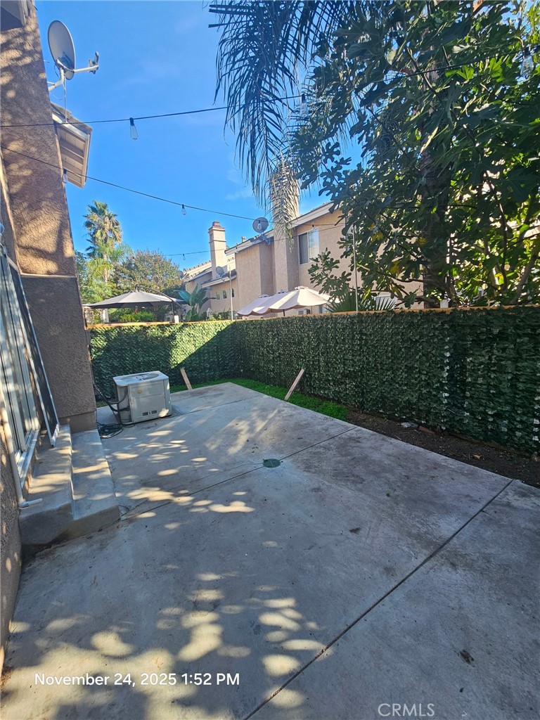 7367 Belpine Place Rancho Cucamonga, CA 91730 - Photo 14 of 15 a view of a patio with table and chairs with wooden fence