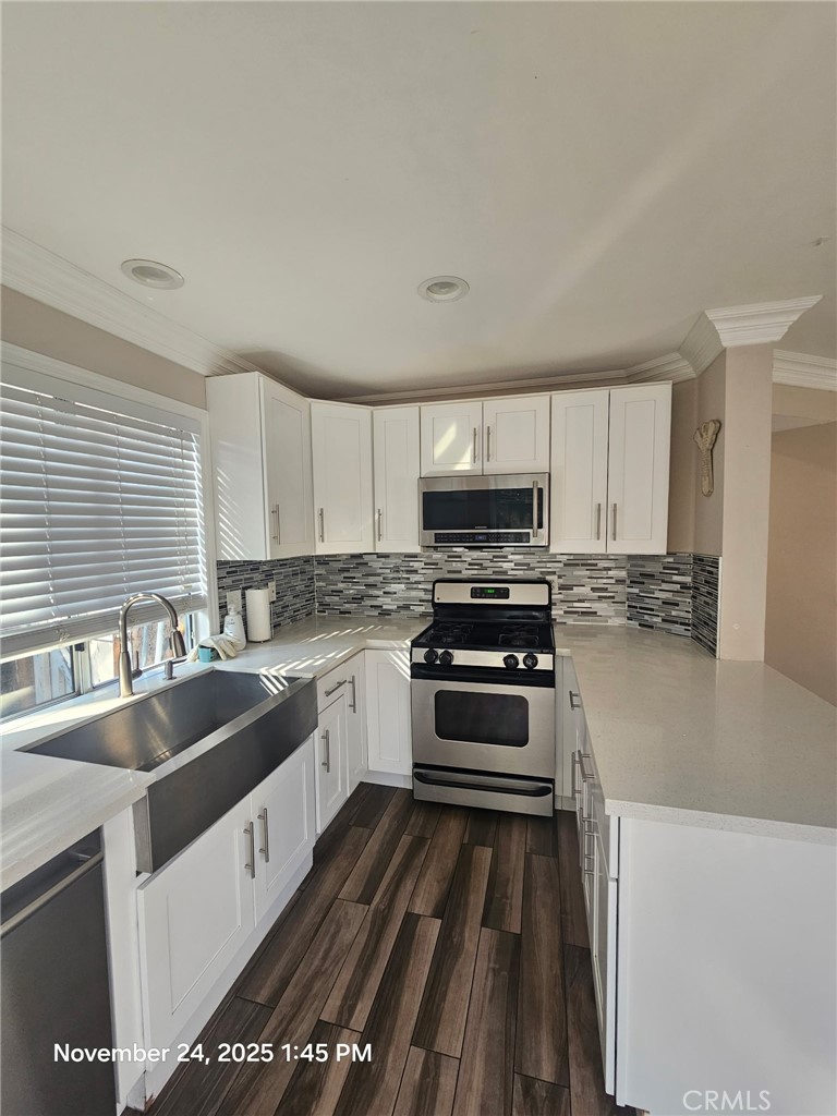 7367 Belpine Place Rancho Cucamonga, CA 91730 - Photo 6 of 15 a kitchen with granite countertop a sink a counter top space appliances and cabinets