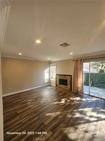 a view of empty room with a fireplace