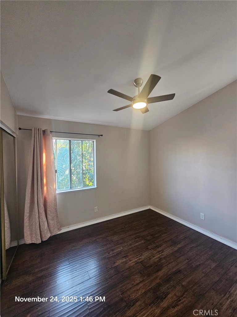 7367 Belpine Place Rancho Cucamonga, CA 91730 - Photo 8 of 15 an empty room with wooden floor fan and windows