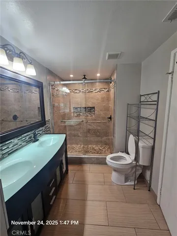 a bathroom with a toilet a sink and a shower