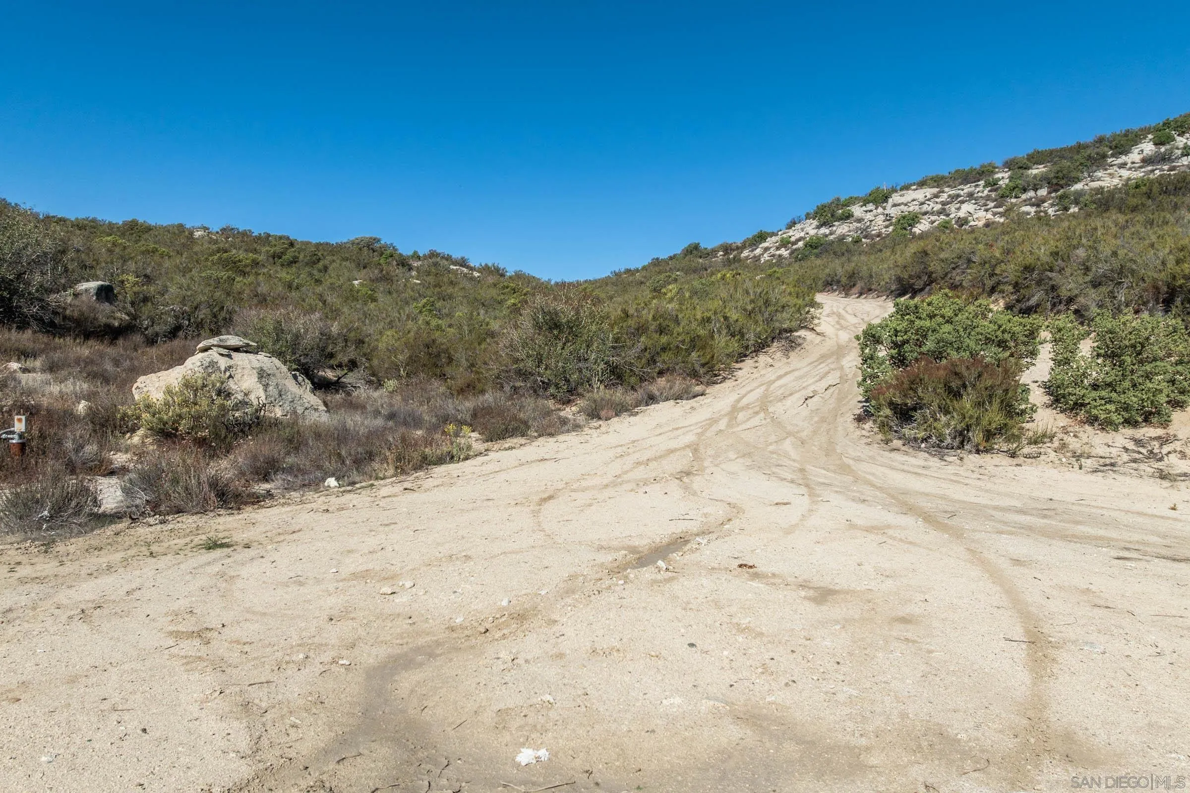 35613 Stagecoach Springs Road, Unit 466 Pine Valley, CA 91962 - Photo 5 of 28 a view of a dry yard with mountains in the background