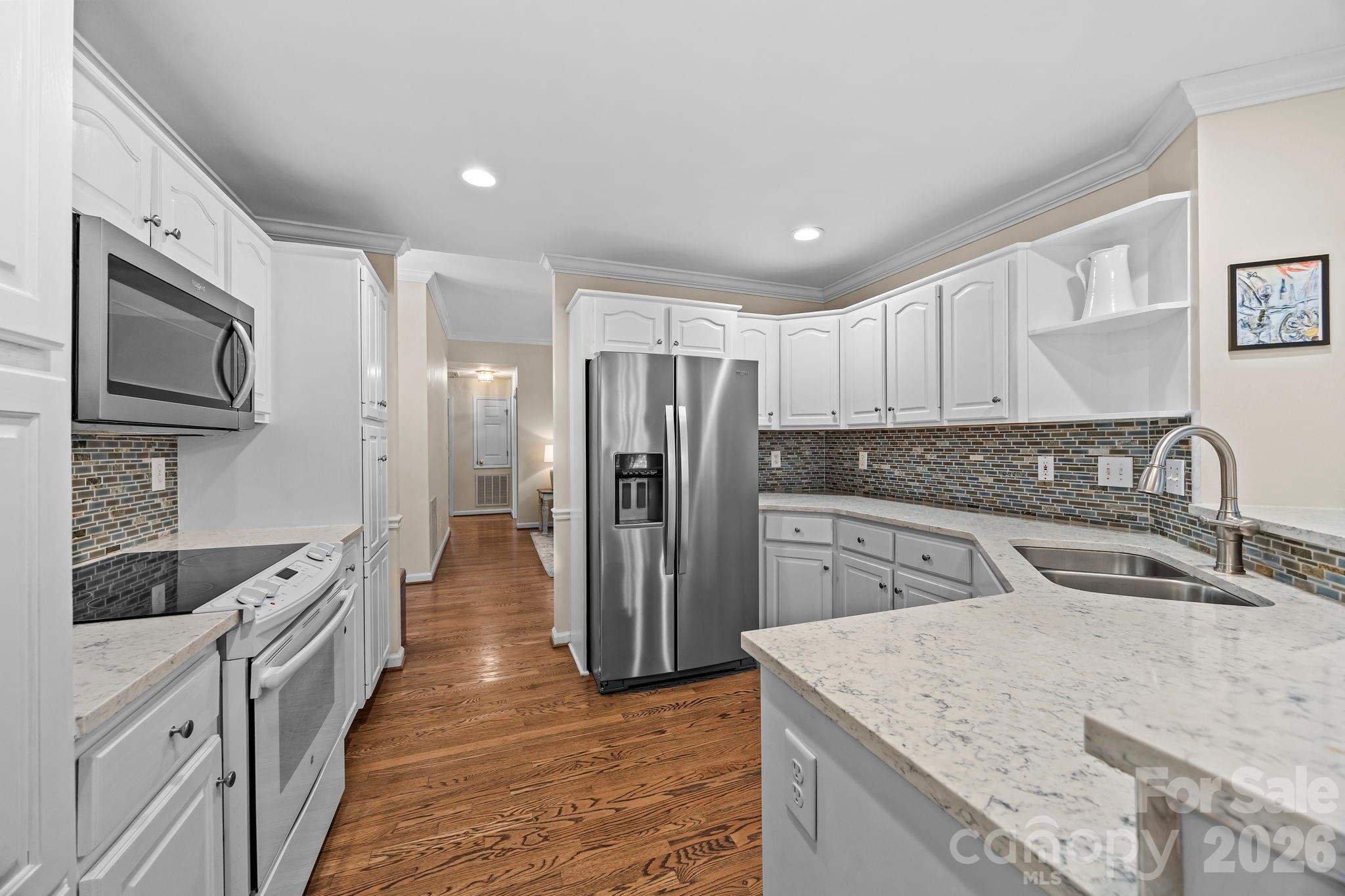 413 Nixon Road Belmont, NC 28012 - Photo 12 of 48 a kitchen with stainless steel appliances granite countertop a sink stove and refrigerator