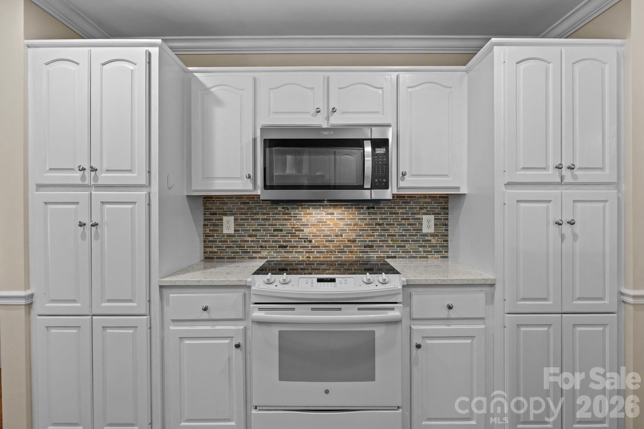413 Nixon Road Belmont, NC 28012 - Photo 15 of 48 a kitchen with white cabinets and white appliances