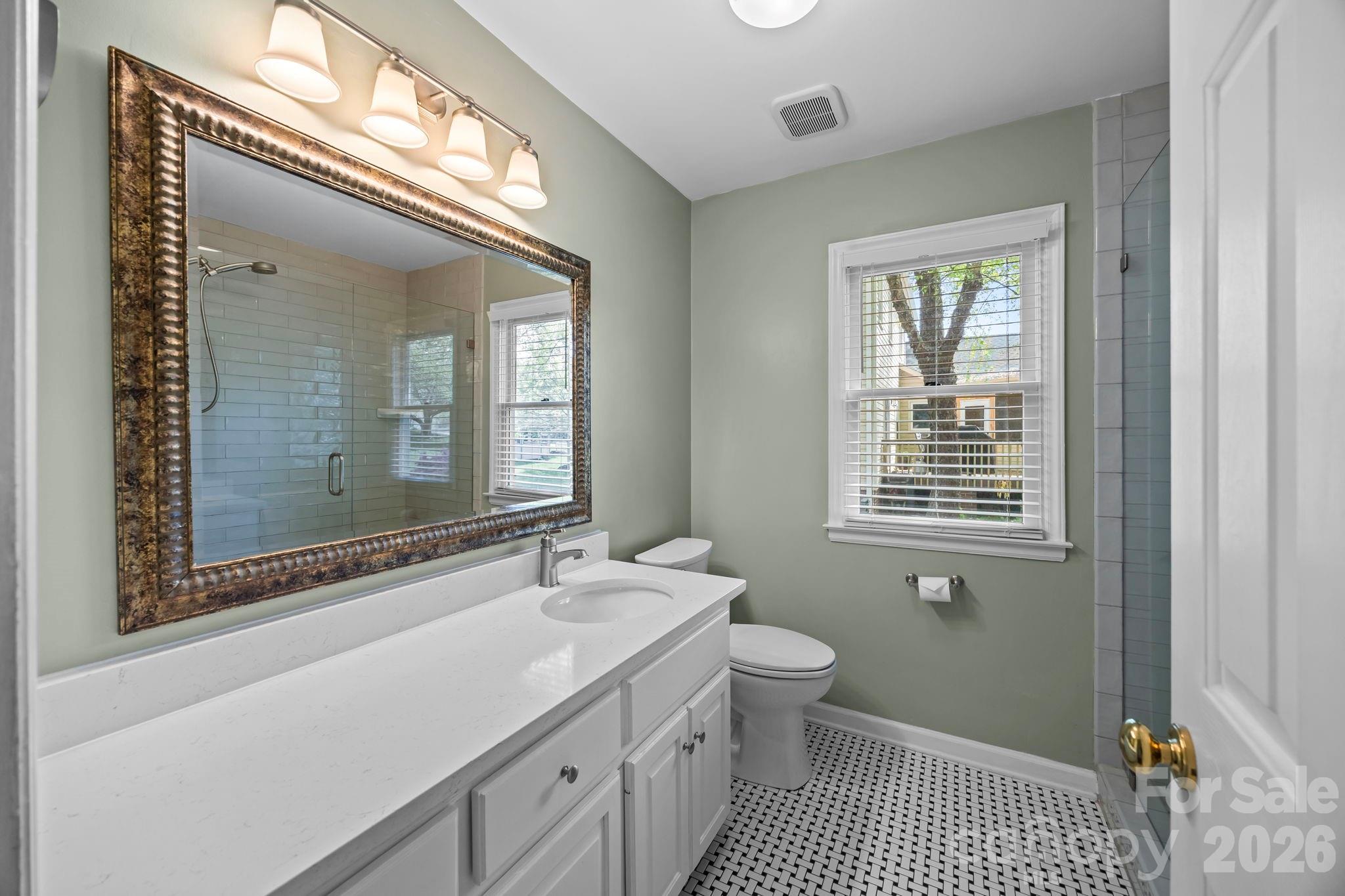 413 Nixon Road Belmont, NC 28012 - Photo 23 of 48 a bathroom with a sink a toilet and a mirror