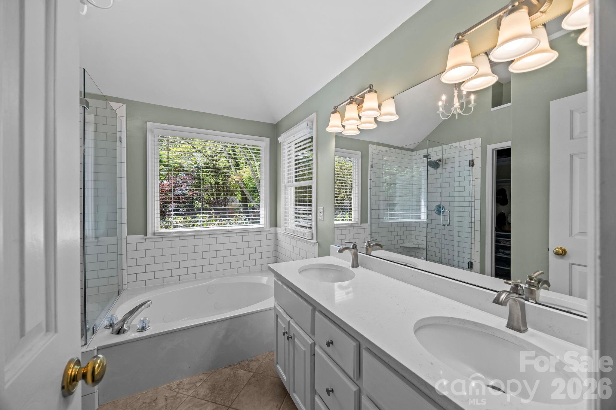 413 Nixon Road Belmont, NC 28012 - Photo 27 of 48 a bathroom with a tub double sink window and mirror