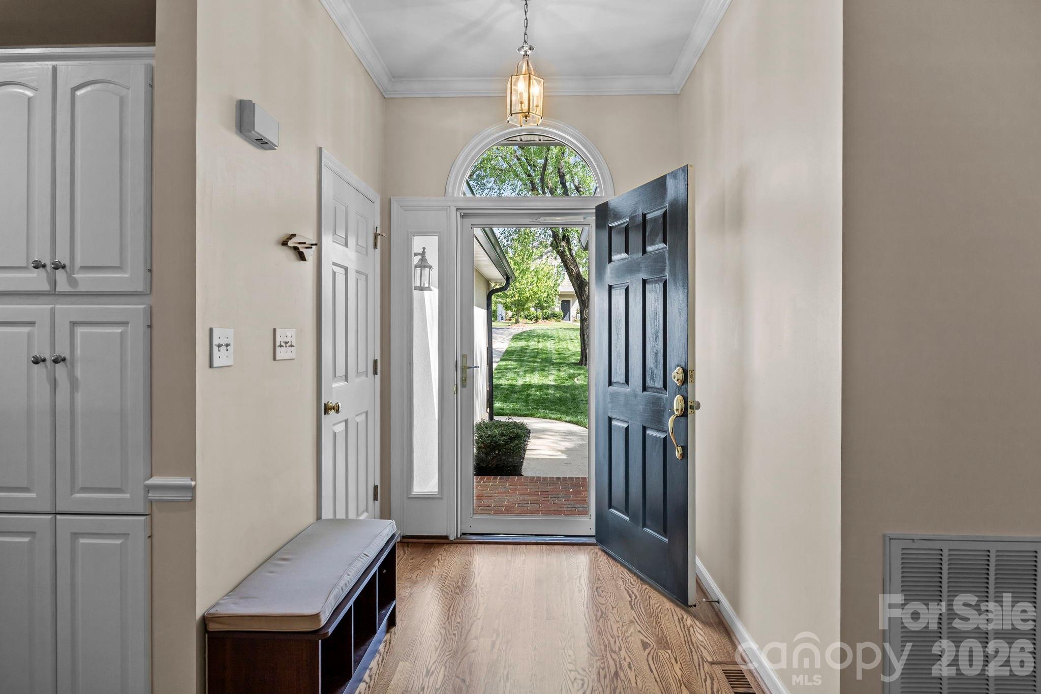 413 Nixon Road Belmont, NC 28012 - Photo 4 of 48 a hallway with sliding door and chandelier