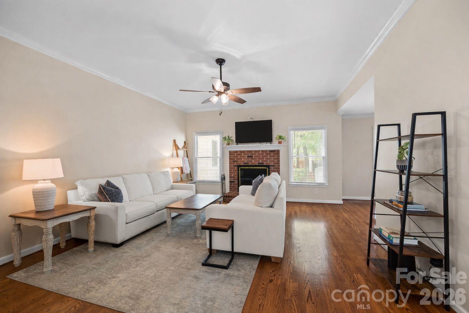 413 Nixon Road Belmont, NC 28012 - Photo 5 of 48 a living room with furniture a fireplace and a flat screen tv