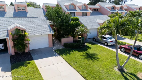 an aerial view of a house with garden space and a patio