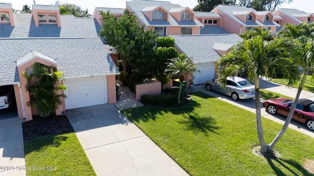 an aerial view of a house with garden space and a patio