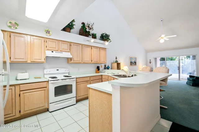 a kitchen with a stove sink and cabinets