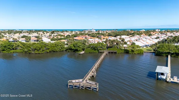 an aerial view of a ocean with boats