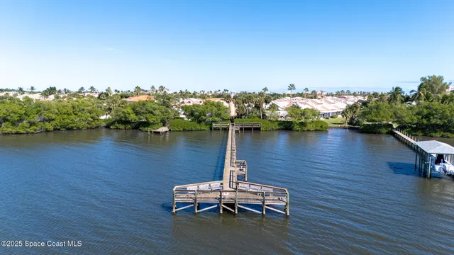 a table and chairs sitting in a wooden deck next to a lake