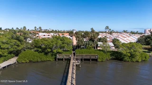 an aerial view of a house with outdoor space lake view and mountain view