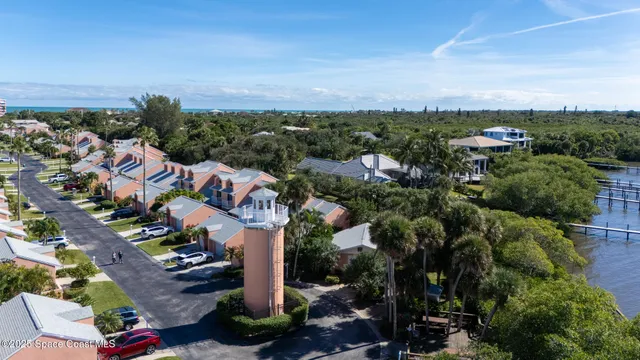 an aerial view of a house with swimming pool and lake view