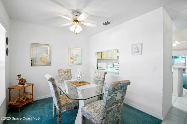 a view of a dining room with furniture and a livingroom