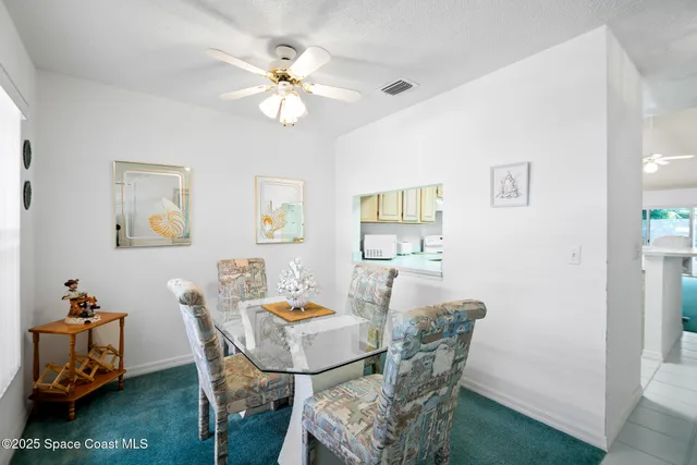 a view of a dining room with furniture and a livingroom