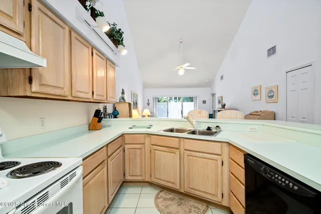 a kitchen with a sink dishwasher and cabinets