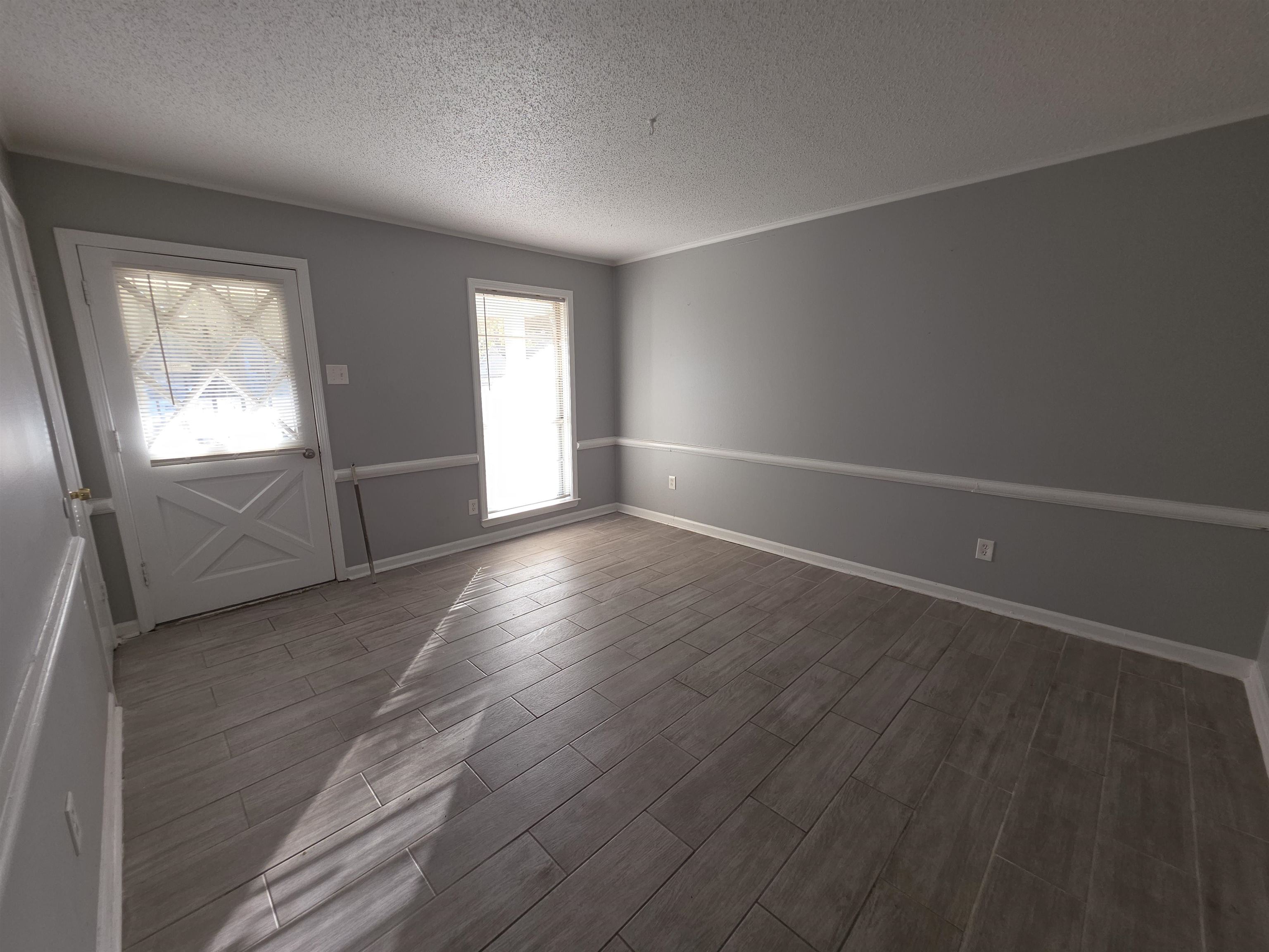 936 Chesterton Drive Memphis, TN 38127 - Photo 14 of 28 an empty room with wooden floor and windows