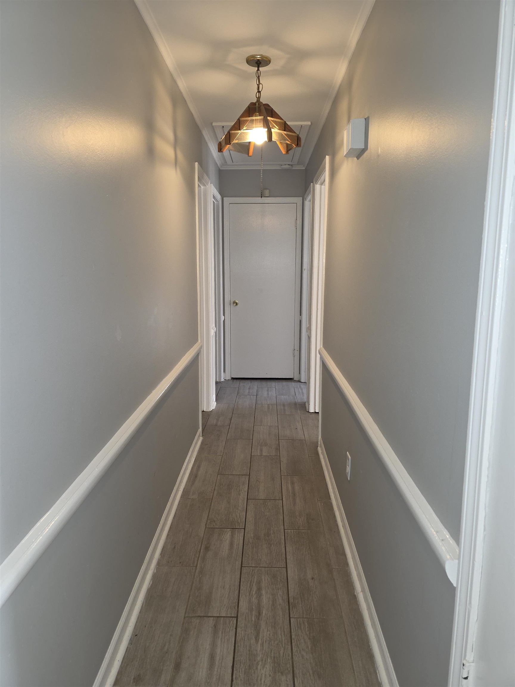 936 Chesterton Drive Memphis, TN 38127 - Photo 16 of 28 a view of a hallway with wooden floor and a chandelier