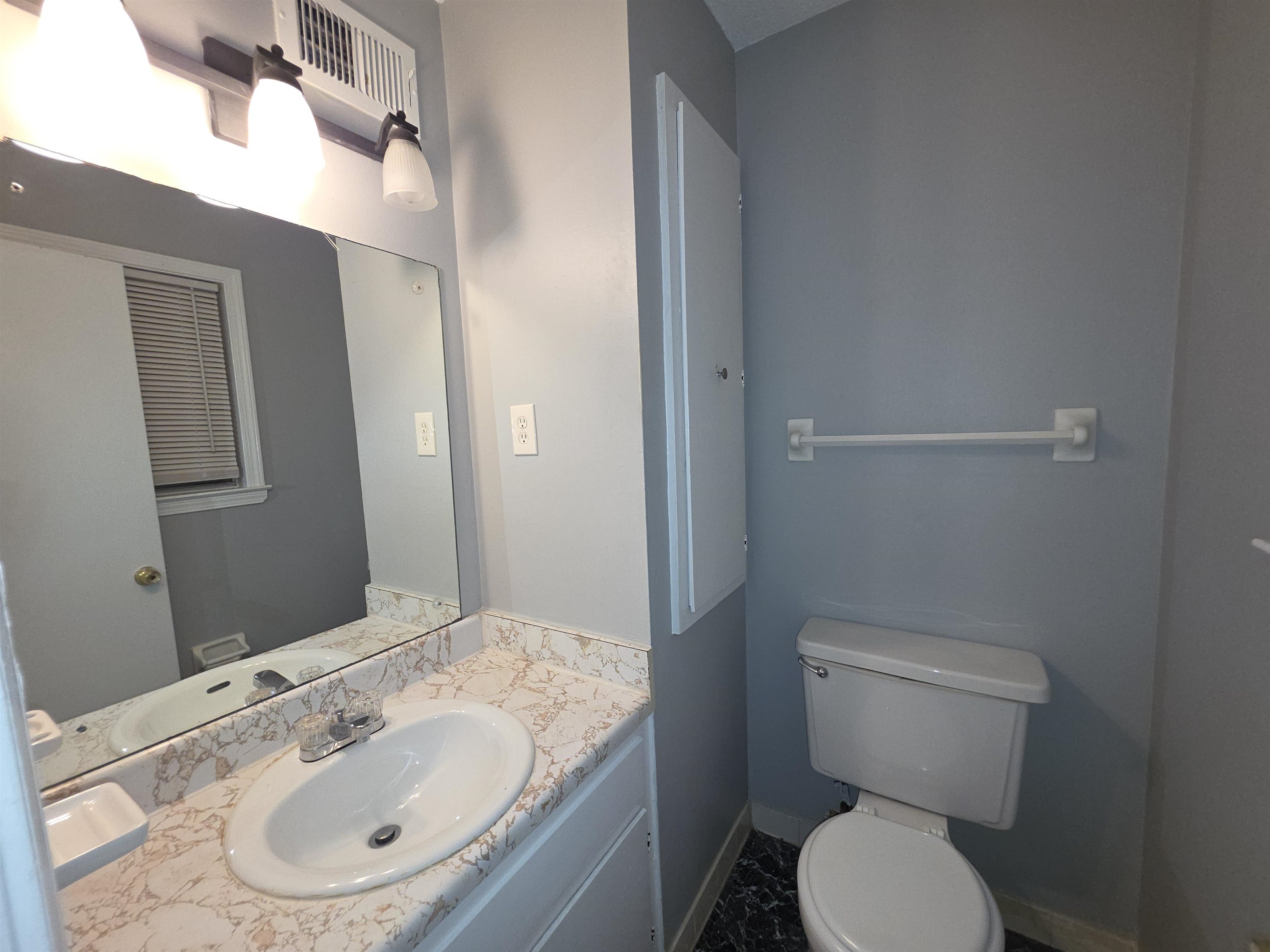 936 Chesterton Drive Memphis, TN 38127 - Photo 23 of 28 a bathroom with a granite countertop toilet sink and mirror