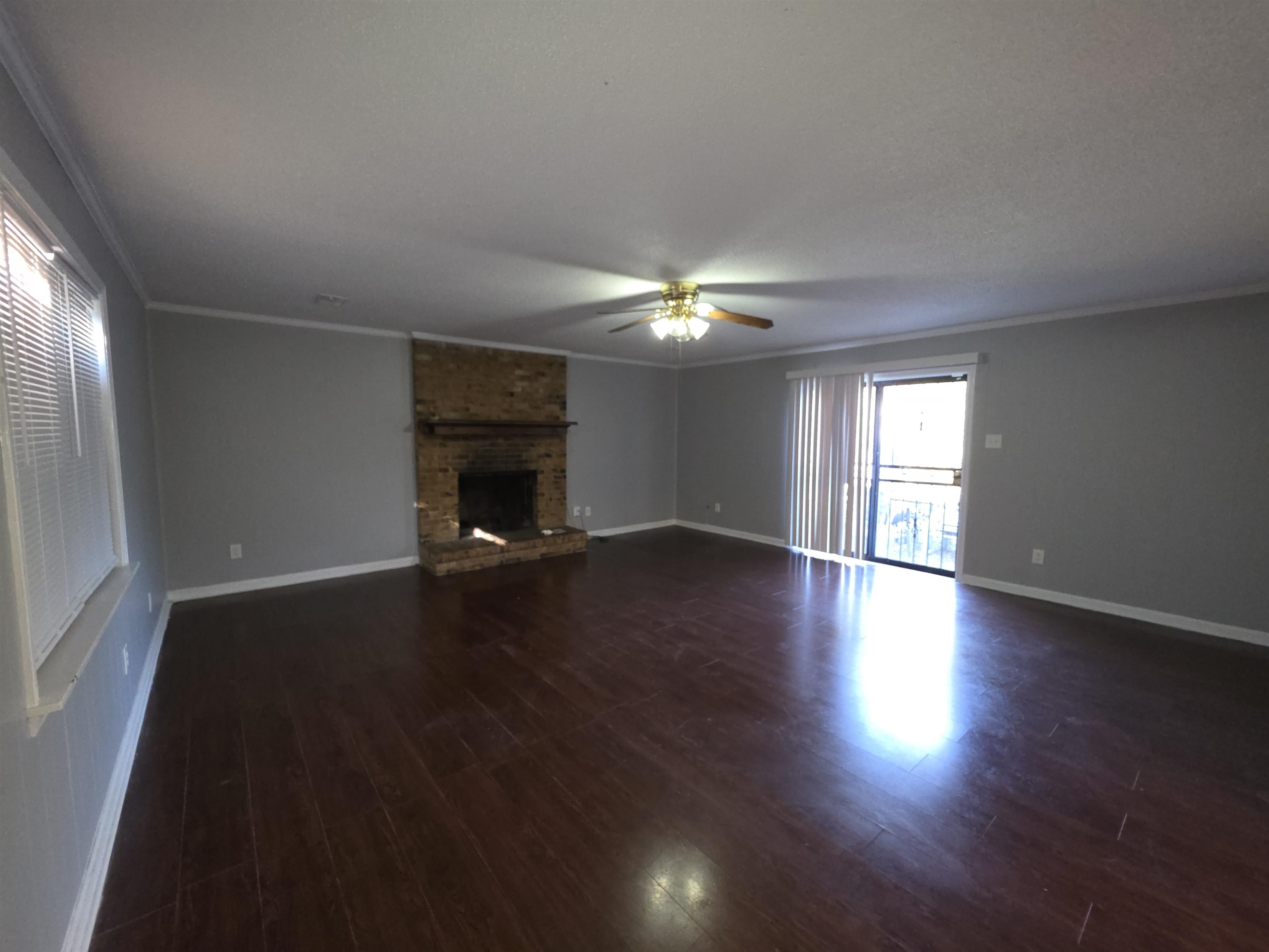 936 Chesterton Drive Memphis, TN 38127 - Photo 5 of 28 an empty room with wooden floor fireplace and windows