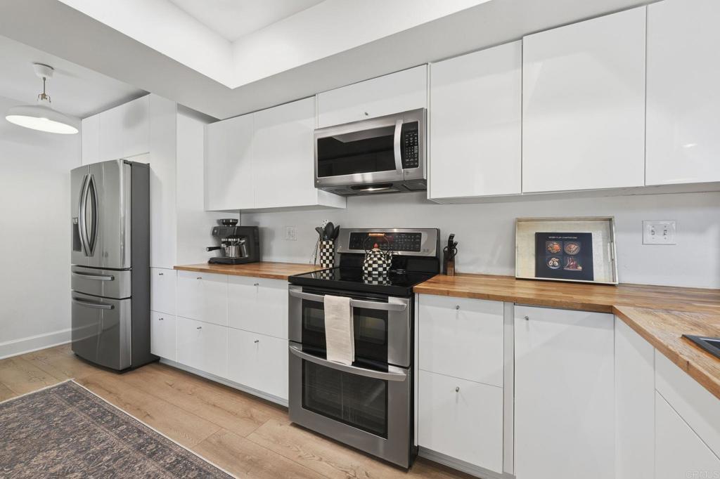 2972 Lancaster Road Carlsbad, CA 92010 - Photo 11 of 36 a kitchen with stainless steel appliances granite countertop a refrigerator stove and sink