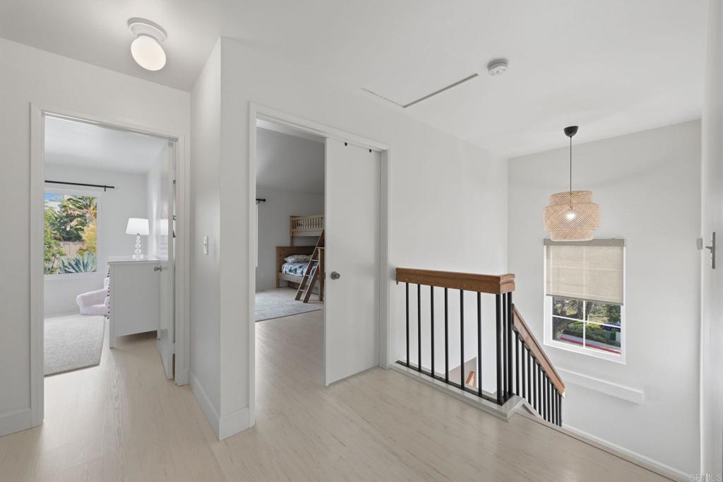 2972 Lancaster Road Carlsbad, CA 92010 - Photo 16 of 36 a view of a hallway with bathroom and wooden floor