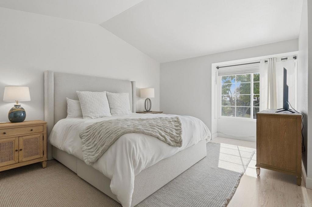 2972 Lancaster Road Carlsbad, CA 92010 - Photo 23 of 36 a spacious bedroom with a bed and wooden floor
