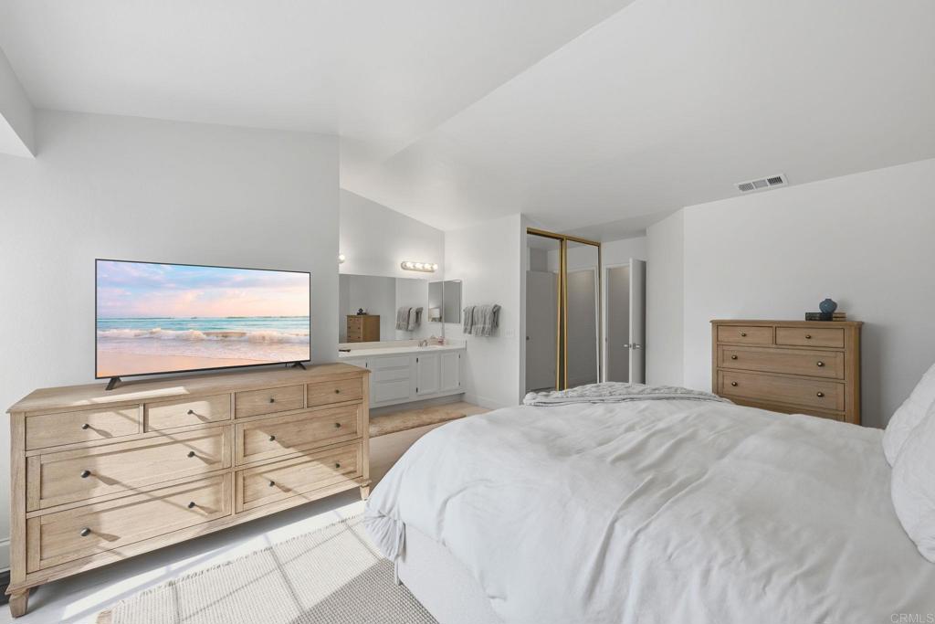2972 Lancaster Road Carlsbad, CA 92010 - Photo 25 of 36 a spacious bedroom with a bed and mirror