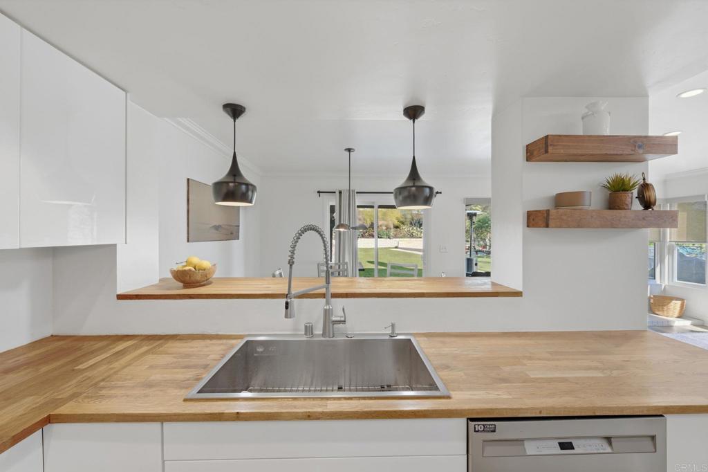 2972 Lancaster Road Carlsbad, CA 92010 - Photo 10 of 36 a kitchen with kitchen island a sink and wooden floor