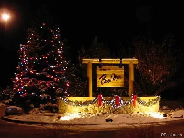 a sign that is sitting in front of flowers