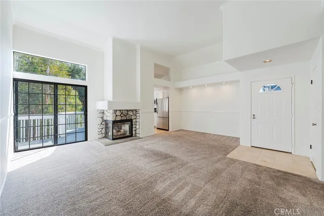 a view of an empty room and fire place