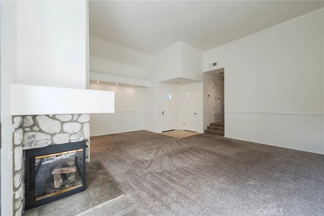 a kitchen with granite countertop white cabinets and a window