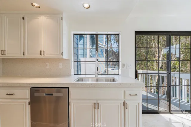 a kitchen with stainless steel appliances white cabinets and a stove